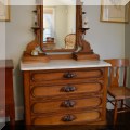 F66. Four-drawer oak dresser with fruit carved pulls and mirror with candle stands. 